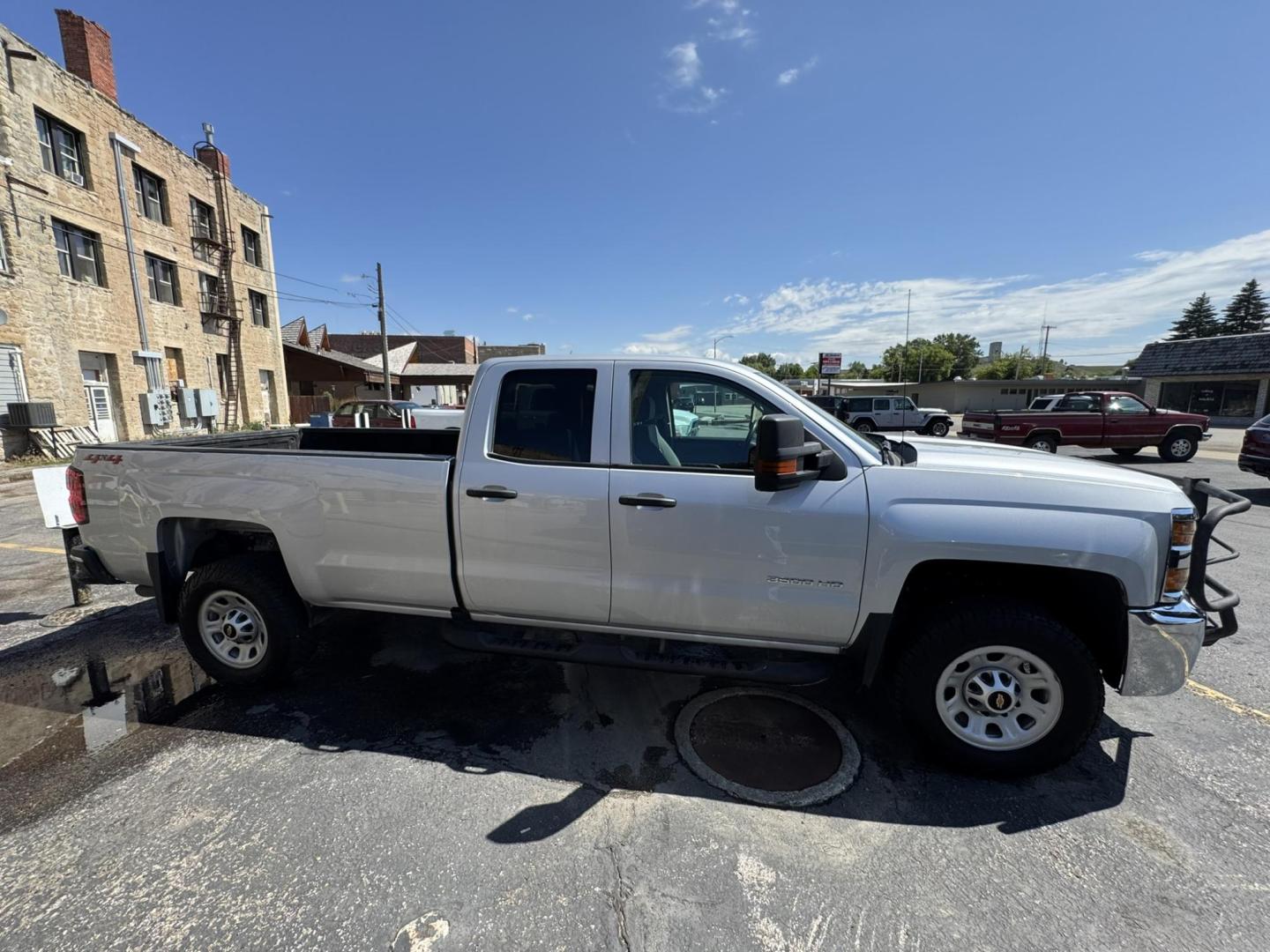 2018 Silver /Grey Chevrolet Silverado 3500HD Work Truck Double Cab Long Box 4WD (1GC2KYEG4JZ) with an 6.0L V8 OHV 16V FFV engine, 6A transmission, located at 116 5th Avenue South, Lewistown, MT, 59457, 47.063877, -109.427879 - If you need serious muscle, this 2018 Chevy Silverado 3500 HD 4x4 Work Truck is built to get the job done. Powered by a proven 6.0L V8 and paired with a heavy-duty 6-speed automatic, this long box double cab hauls, tows, and handles business without breaking a sweat. 4WD gives you confident tractio - Photo#1