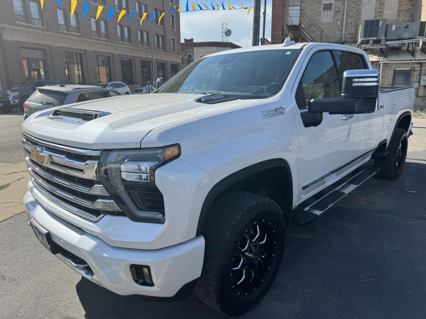 2024 WHITE /Black/Brown Chevrolet Silverado 2500HD High Country Crew Cab Short Box 4WD (1GC4YRE75RF) with an 6.6L V8 OHV 16V engine, 6A transmission, located at 116 5th Avenue South, Lewistown, MT, 59457, 47.063877, -109.427879 - Here’s the heavy-duty truck that checks every box. This 2024 Silverado 2500HD High Country gives you premium comfort and style with the capability you expect from a Chevy HD. Under the hood is the reliable 6.6L V8 gas engine paired with 4-wheel drive, built to tow, haul, and handle tough jobs with - Photo#0