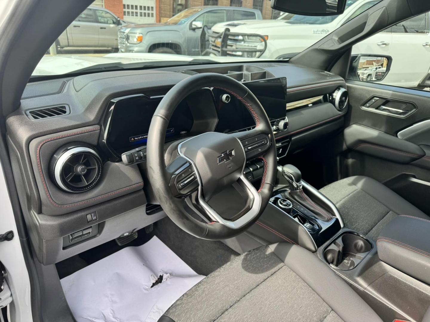 2024 WHITE /Black Chevrolet Colorado Z71 Crew Cab 4WD (1GCPTDEKXR1) with an 2.7L L4 DOHC 16V TURBO engine, 6A transmission, located at 116 5th Avenue South, Lewistown, MT, 59457, 47.063877, -109.427879 - Tough, refined, and built to handle whatever you throw at it—this 2024 Chevrolet Colorado Z71 4WD is the perfect blend of off-road capability and everyday comfort. Powered by a strong turbocharged engine with impressive torque, it delivers confident acceleration, smooth towing capability, and the - Photo#12