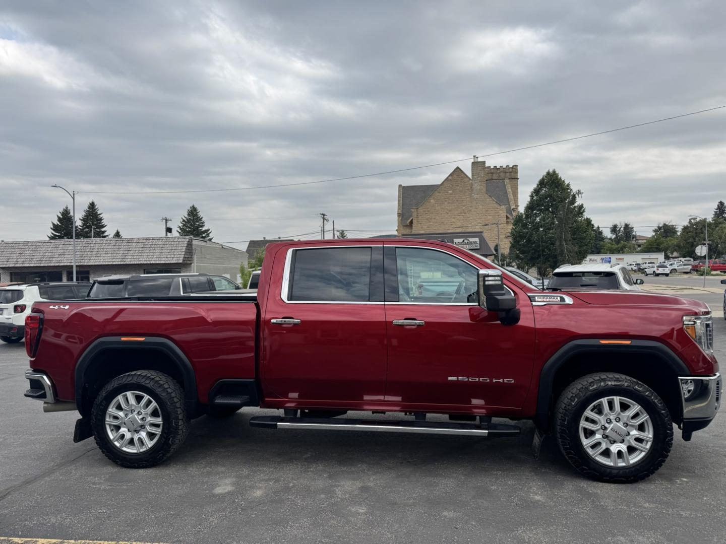2023 Maroon /Tan GMC Sierra 2500HD SLT Crew Cab 2WD (1GT49NEY6PF) with an 6.6L V8 OHV 16V TURBO DIESEL engine, 6A transmission, located at 116 5th Avenue South, Lewistown, MT, 59457, 47.063877, -109.427879 - When it's time to get serious about towing, hauling, or simply driving one of the nicest heavy-duty trucks on the road, this 2023 GMC Sierra 2500HD SLT Crew Cab 4x4 is ready for the job. Powered by the legendary 6.6L Duramax Turbo-Diesel V8 paired with the Allison® 10-speed automatic transmission,- Photo#1